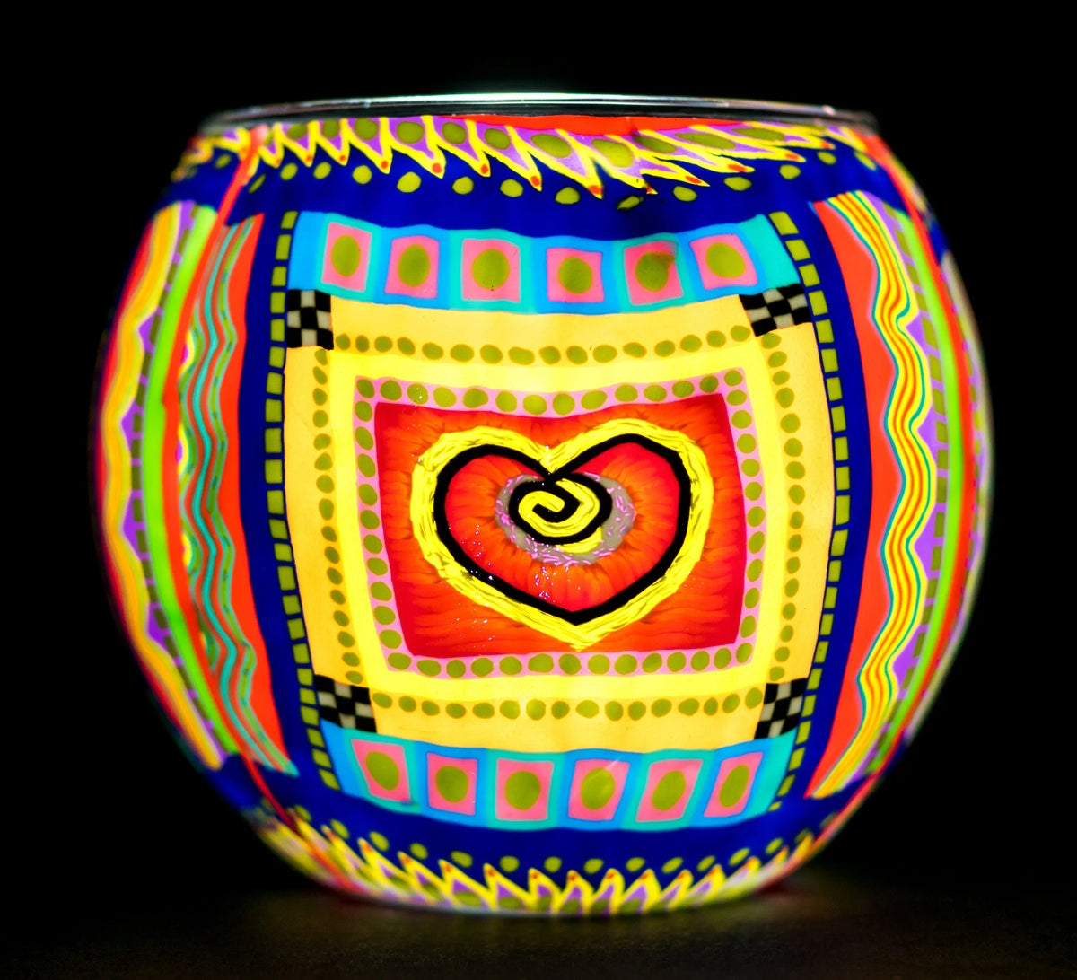 Single Heart Claymaster light globe glowing with a red-orange swirl heart surrounded by colourful folk-art borders of dots, checks and zigzags