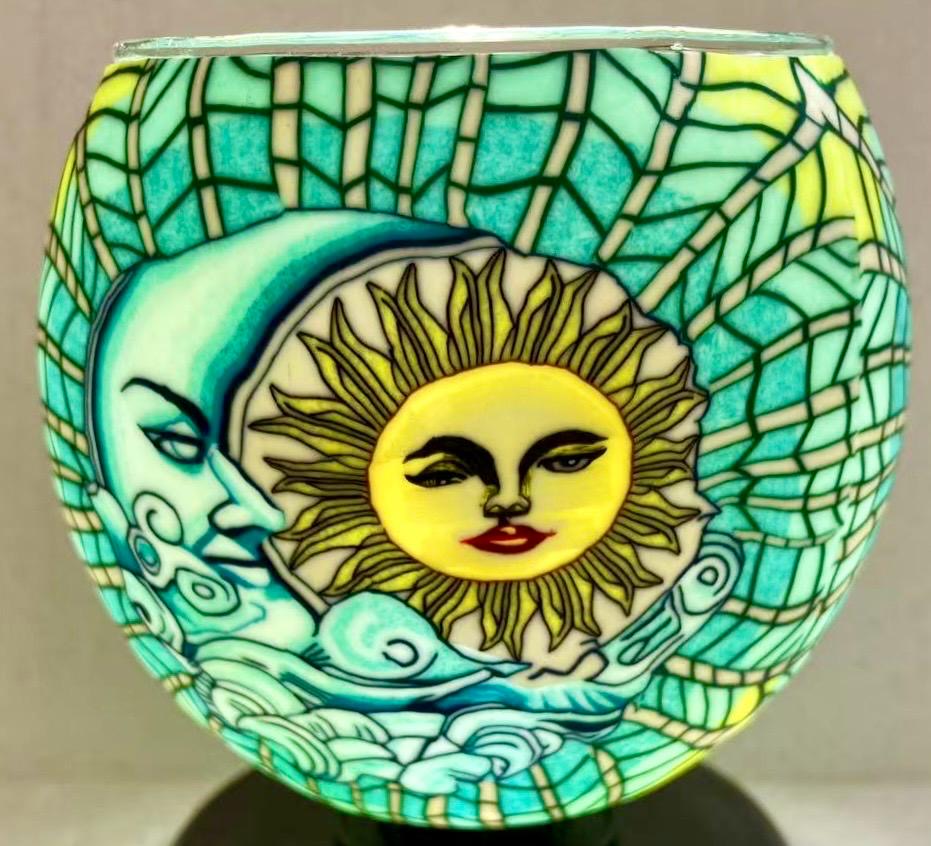 Claymaster Sun and Moon Celestial light globe with sun and crescent moon faces in a teal and gold mosaic, glowing on a dark base