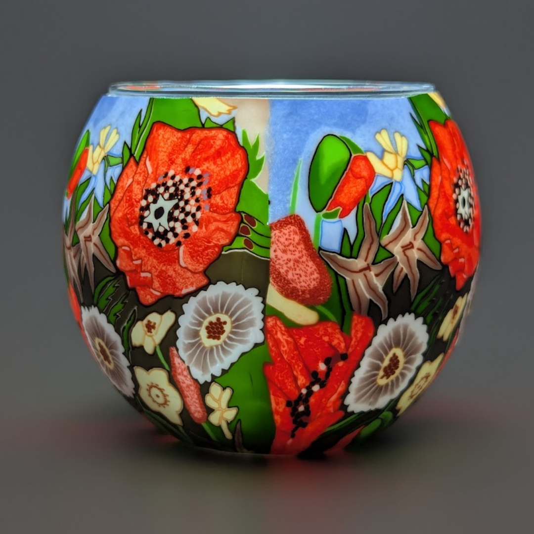 Decorative glass globe with floral patterns on a dark background